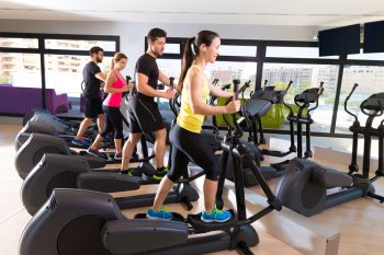 Aerobics elliptical walker trainer group at a gym